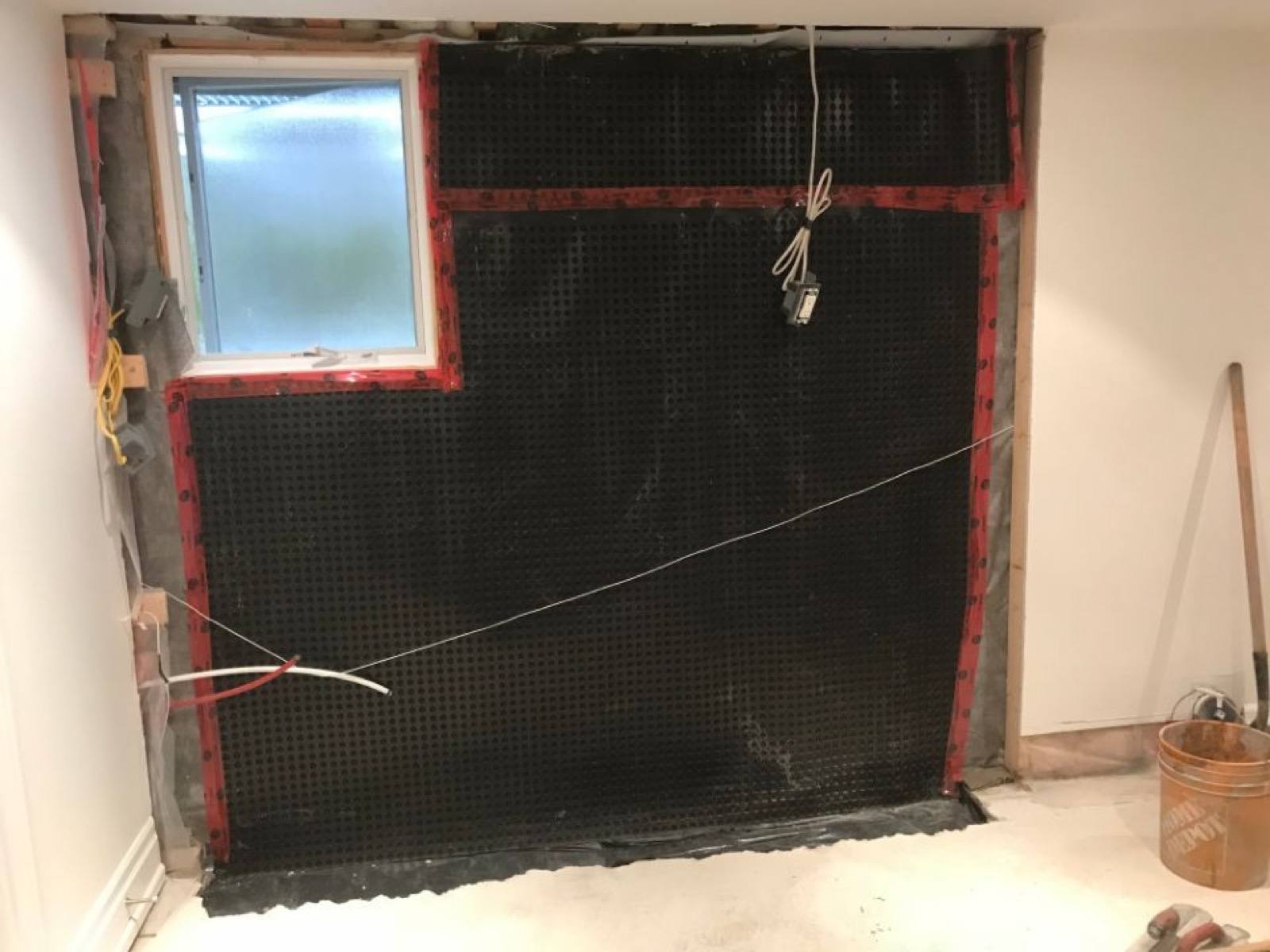 waterproofing being done on the concrete wall 