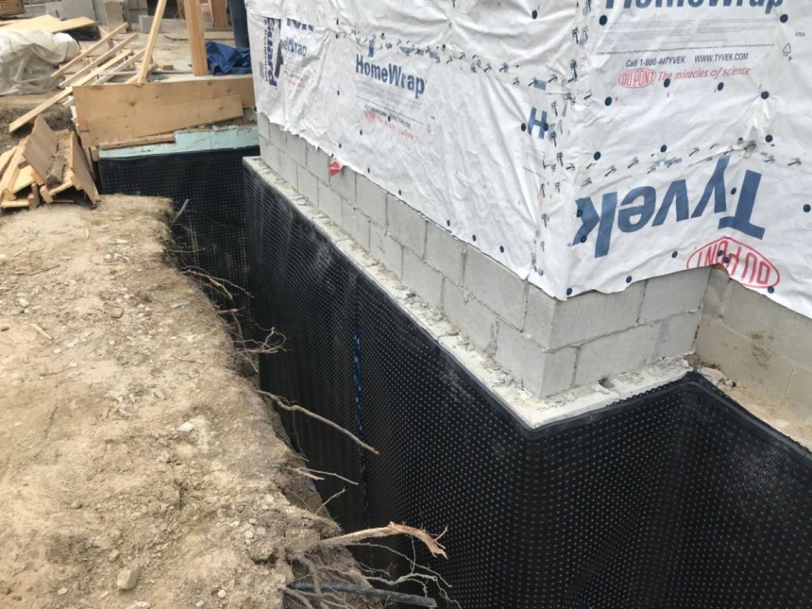 plastic cover attached to the house foundation wall