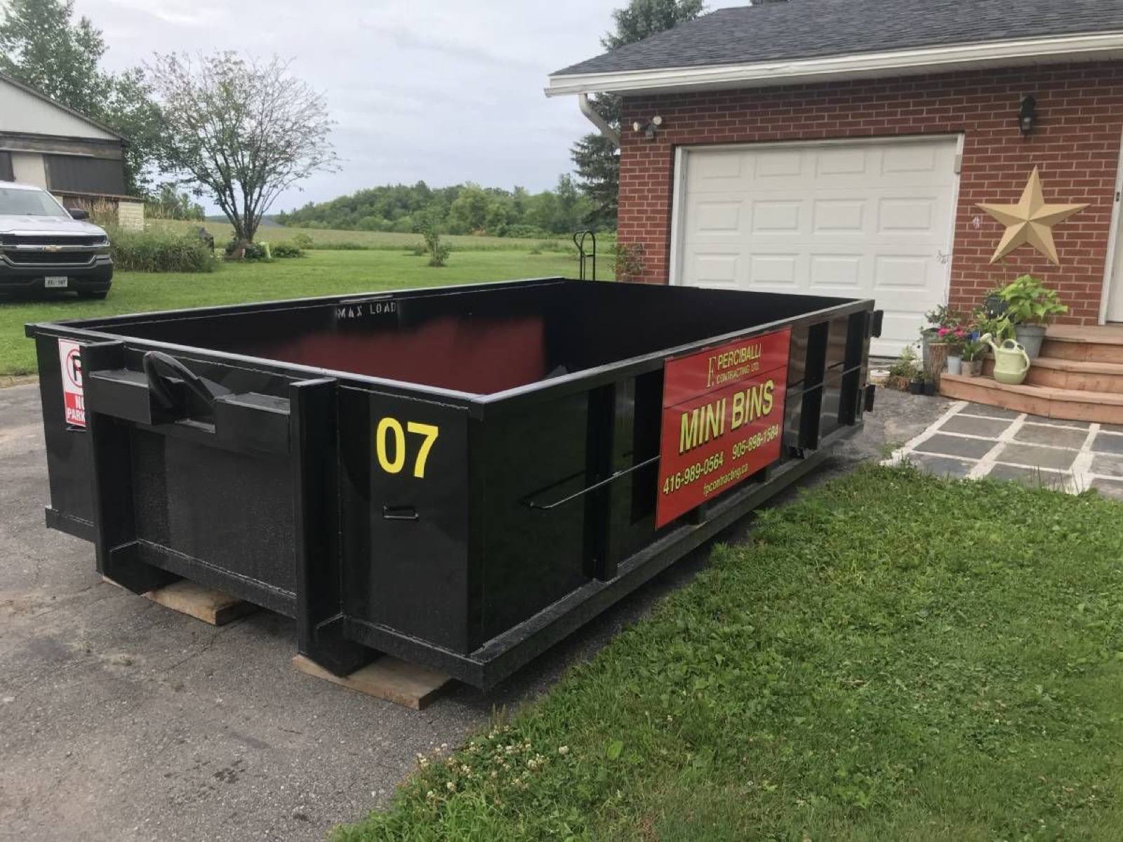big empty bin in front of a gareg