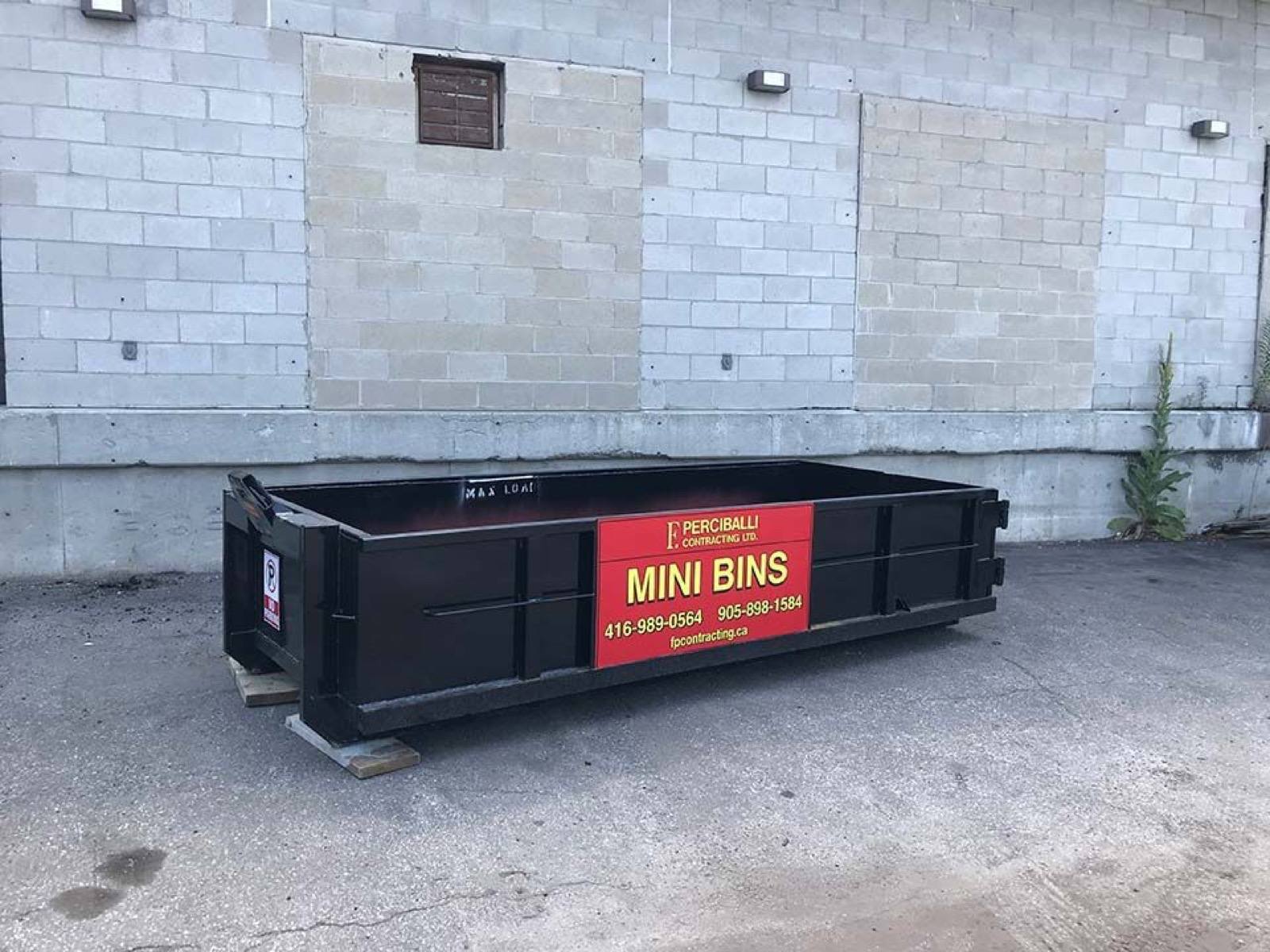 black colour bin placed near a wall