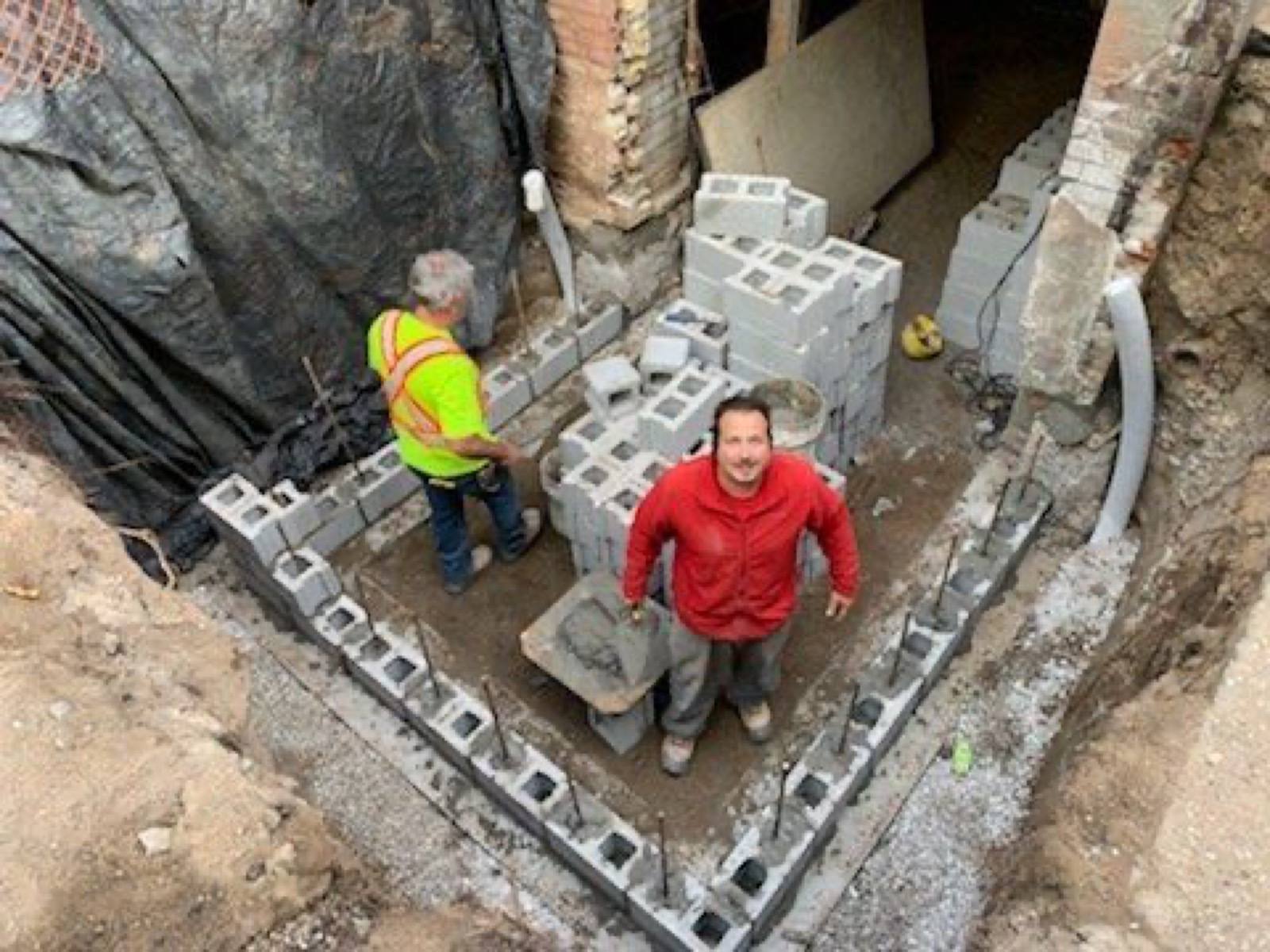 workers looking at the camera during their block work