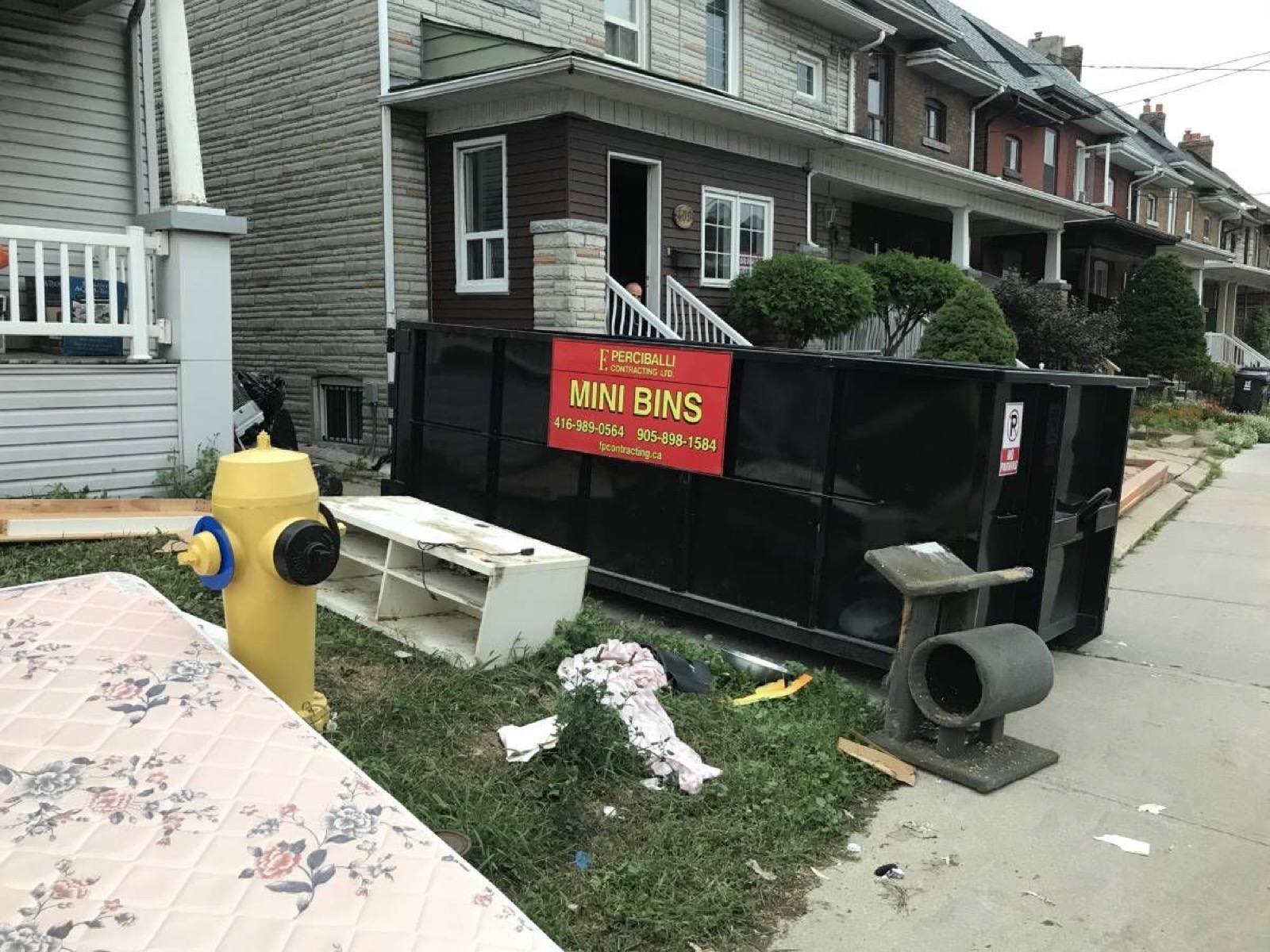 large black bin in front of a house
