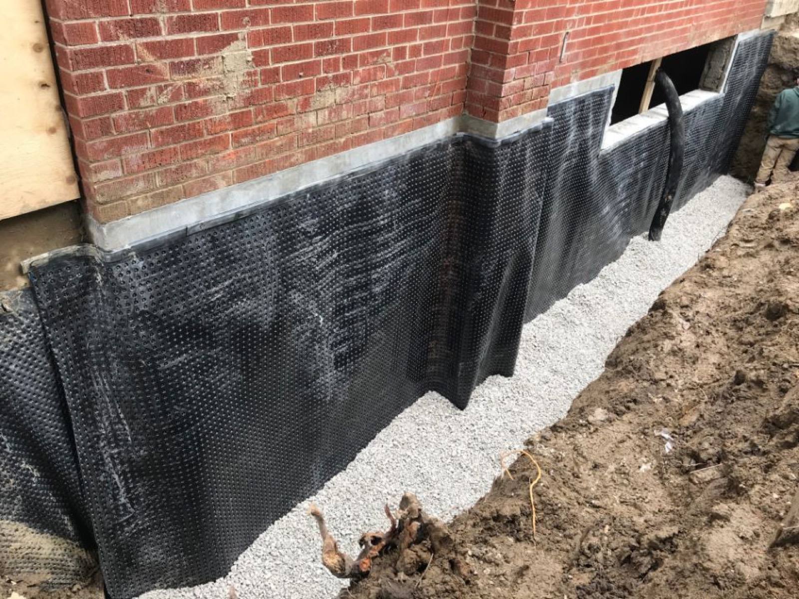 Black plastic sheet covering the basement wall 