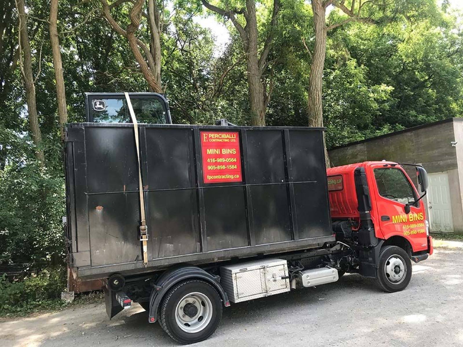 mini bin truck carring an object 