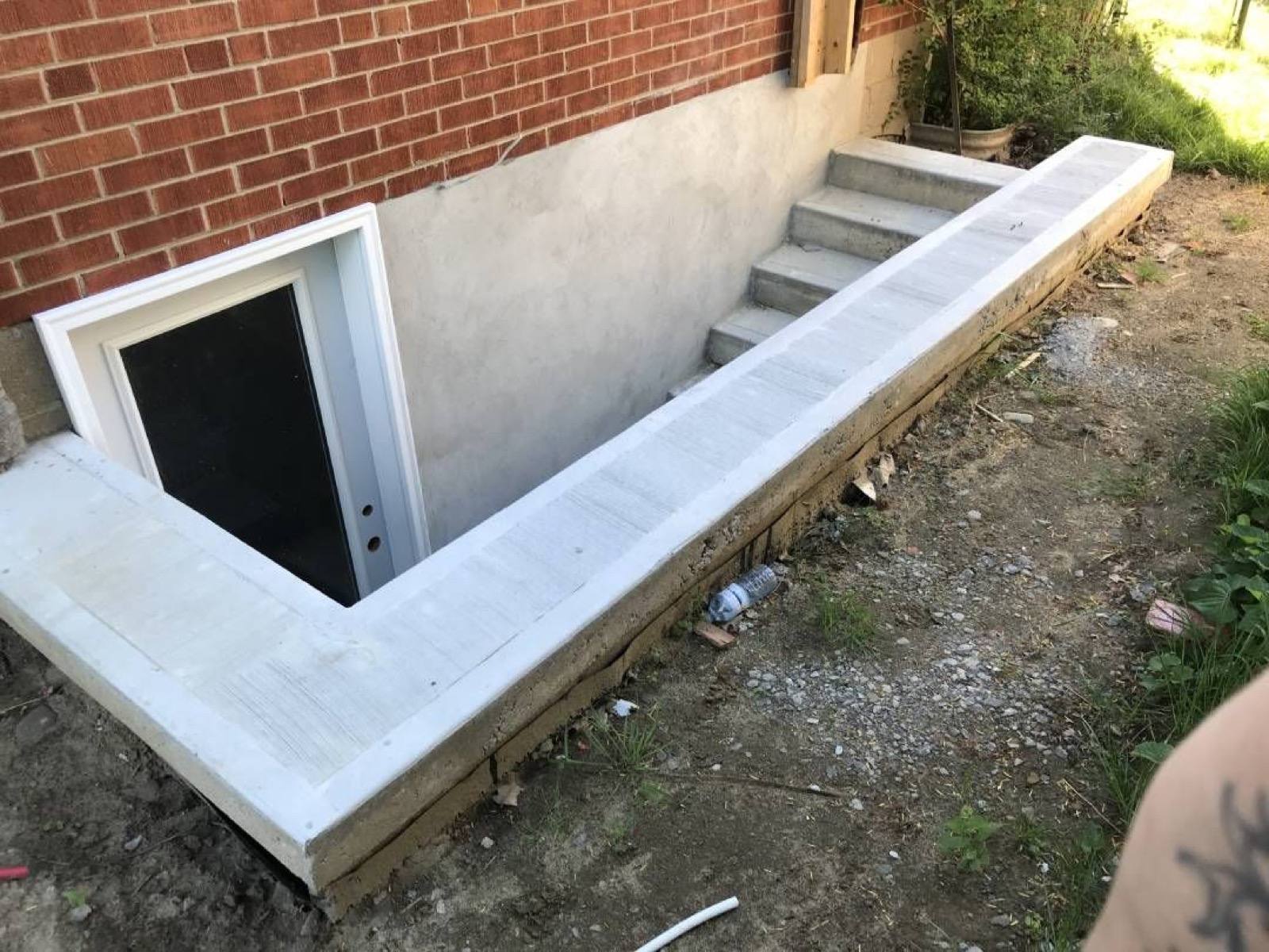 concrete steps leading to a basement door 